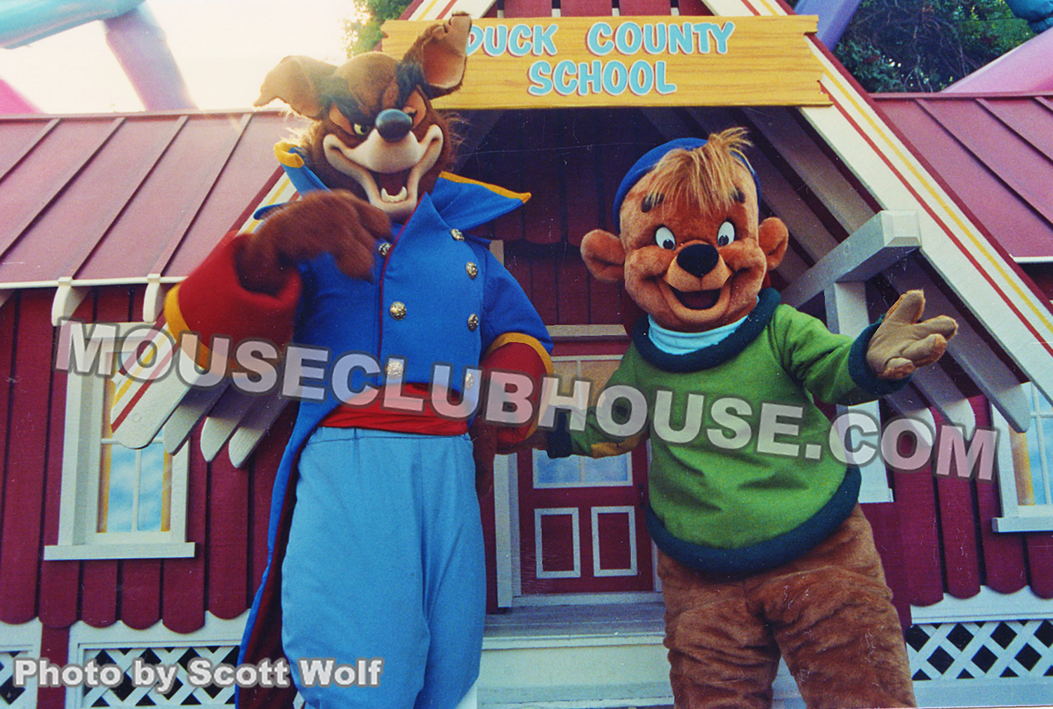 Mixing up shows, characters from TaleSpin pose in front of the DuckTales school in Disneyland